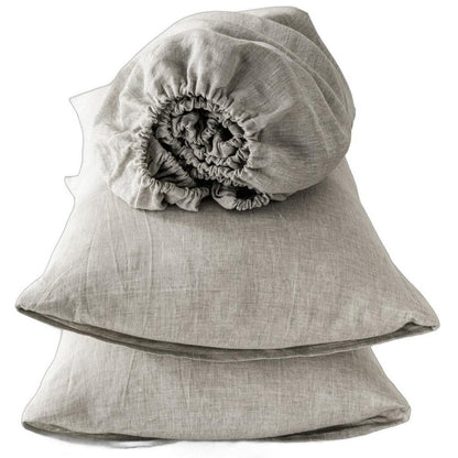 Four piece light gray linen sheet set, folded; soft, textured fabric for sheets and pillowcases.