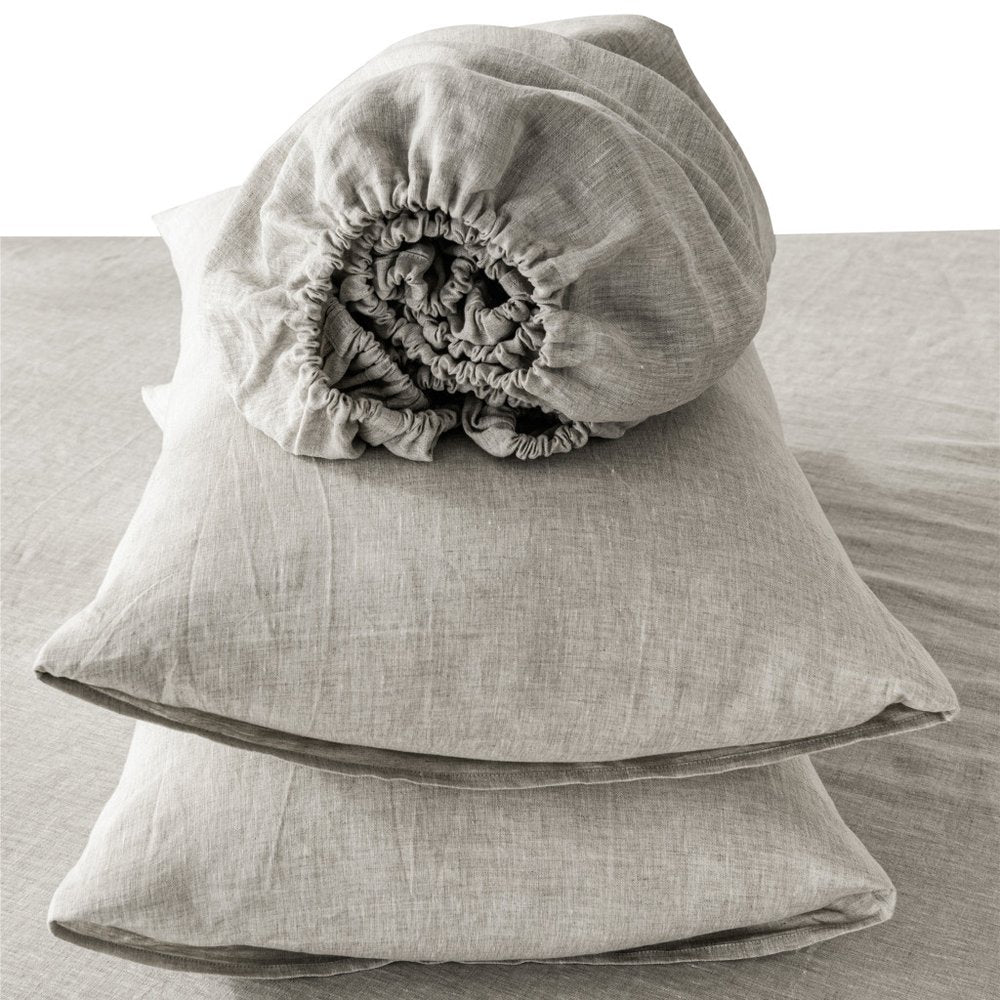 Light gray linen California King sheet set, folded sheets with a rolled linen cover on top.