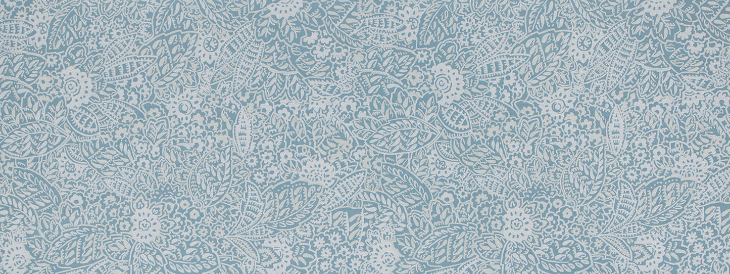 Light blue lace upholstery fabric with white floral motifs and scrolling vine pattern.
