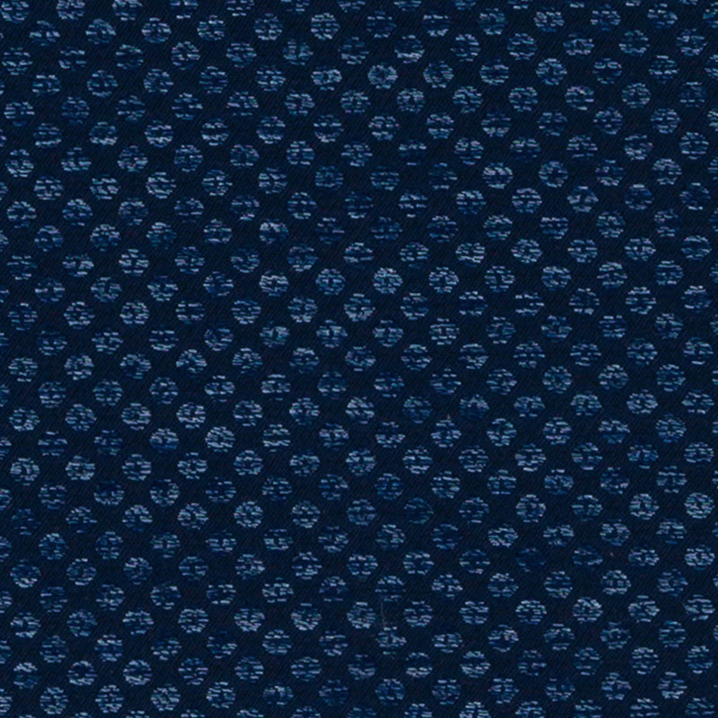 Navy blue fabric with small light-blue circular dotted motifs in a textured weave