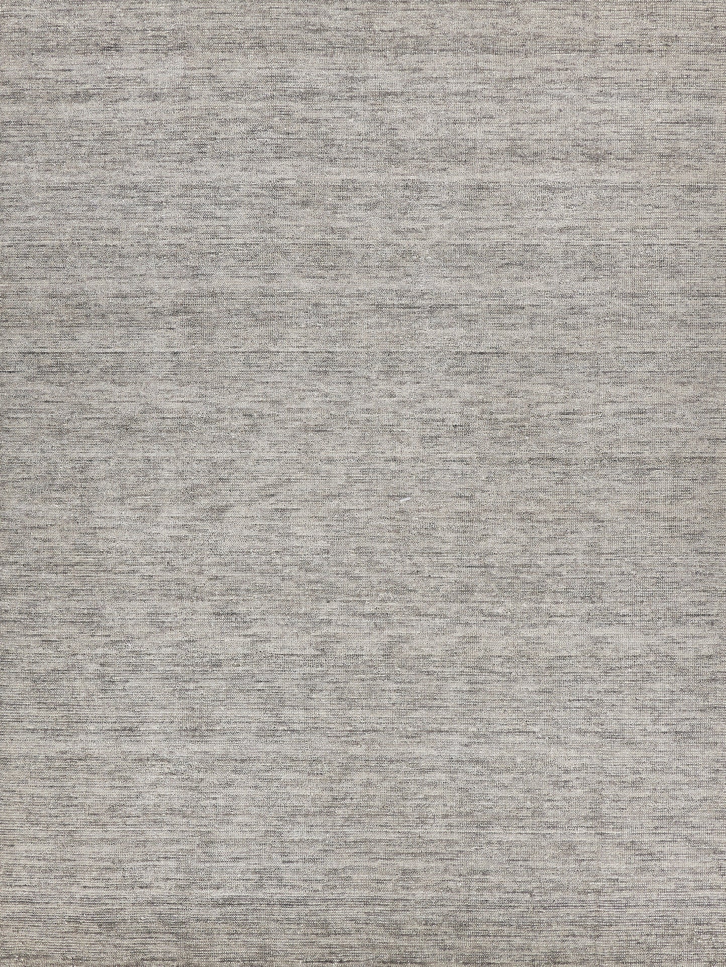 Gray heathered woven rug texture with neutral taupe-gray tones and subtle flat-weave look.