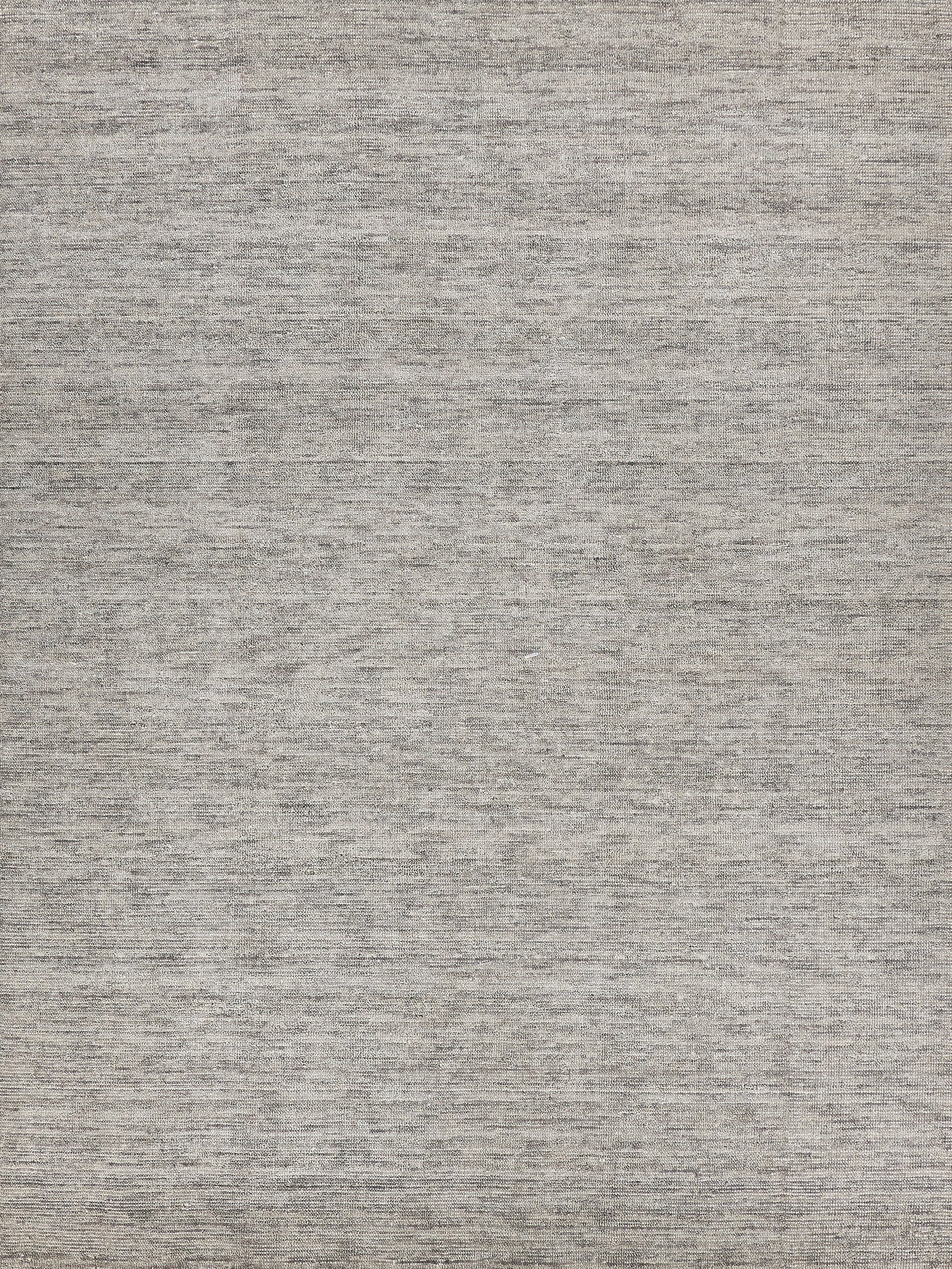 Gray heathered woven rug texture with neutral taupe-gray tones and subtle flat-weave look.