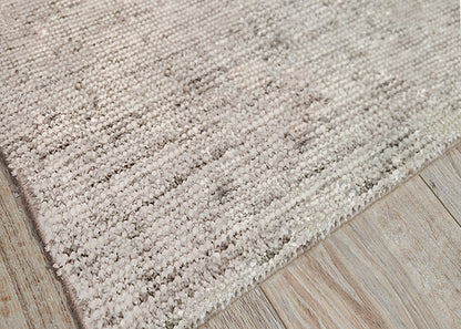 Beige rug with dense pile on light wood floor.