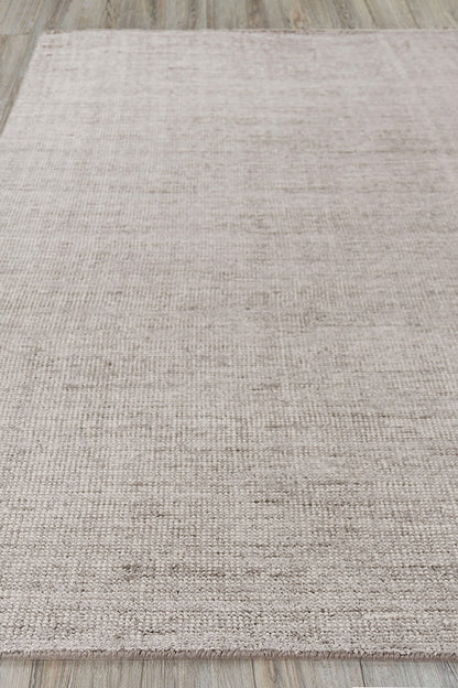 Beige textured area rug with a subtle tonal pattern, low-pile on wood floor