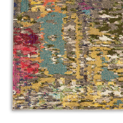 Close-up of abstract multicolor woven rug with teal, yellow, red, gray & beige tones, soft tufted pile.