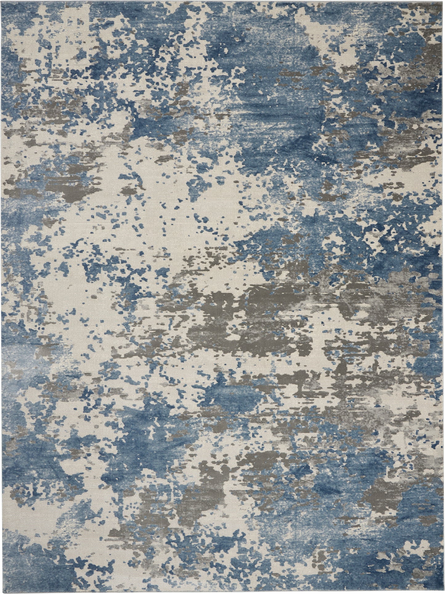 Abstract blue, gray, and beige area rug (9' x 13') with blotchy, painterly pattern.