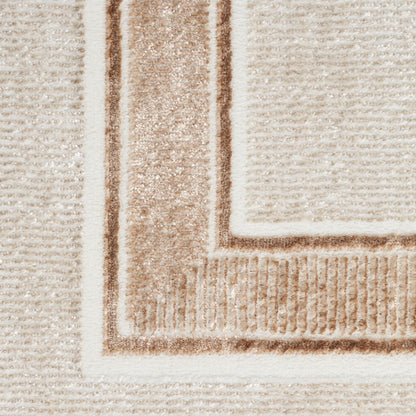 Beige area rug with cream border and tan rectangular frame; soft, plush textured weave.