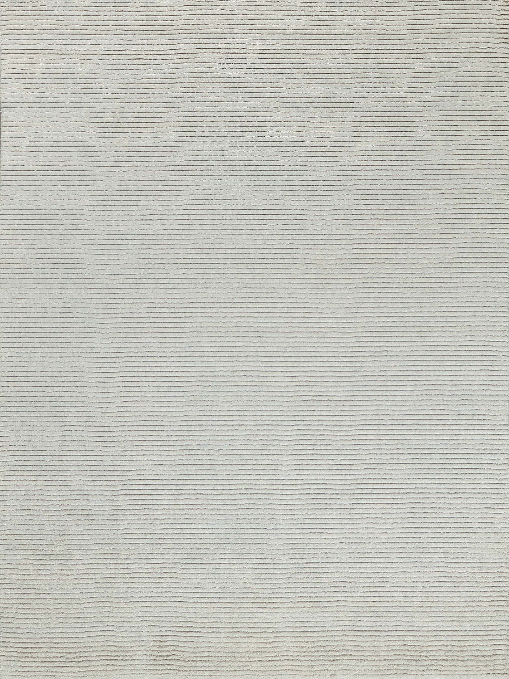 Beige woven rug with subtle horizontal stripes; soft texture for living room decor.
