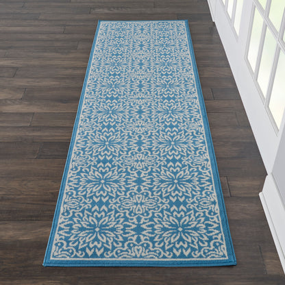 Narrow blue & beige damask-pattern runner rug with teal border on dark wood floor, 7' long.