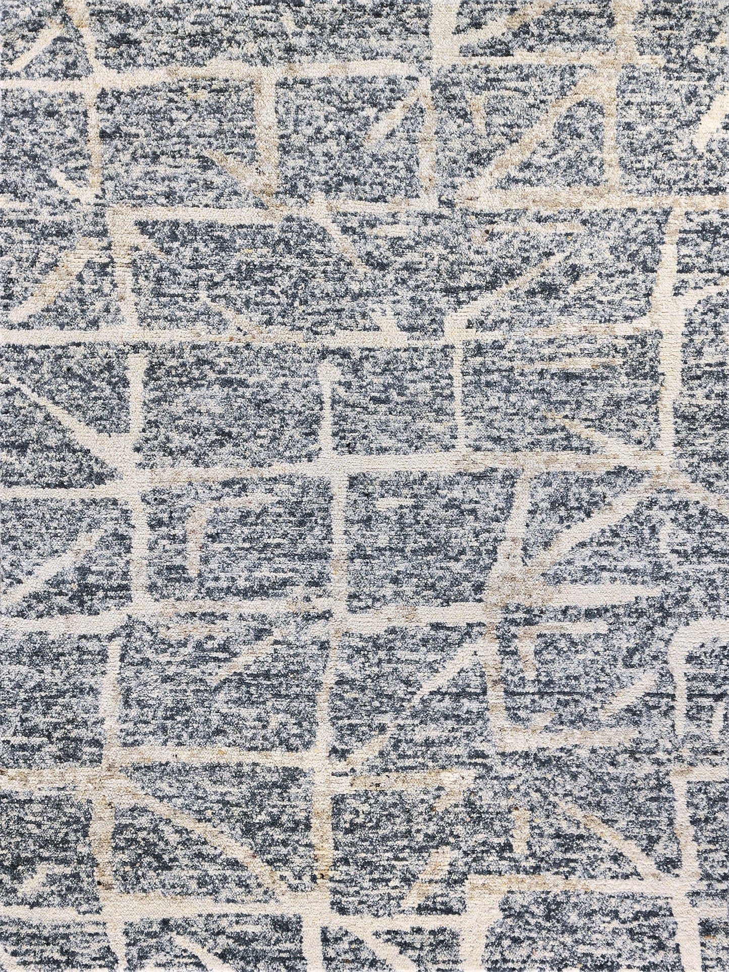 Rectangular blue-gray rug with cream geometric grid pattern and plush textured pile.