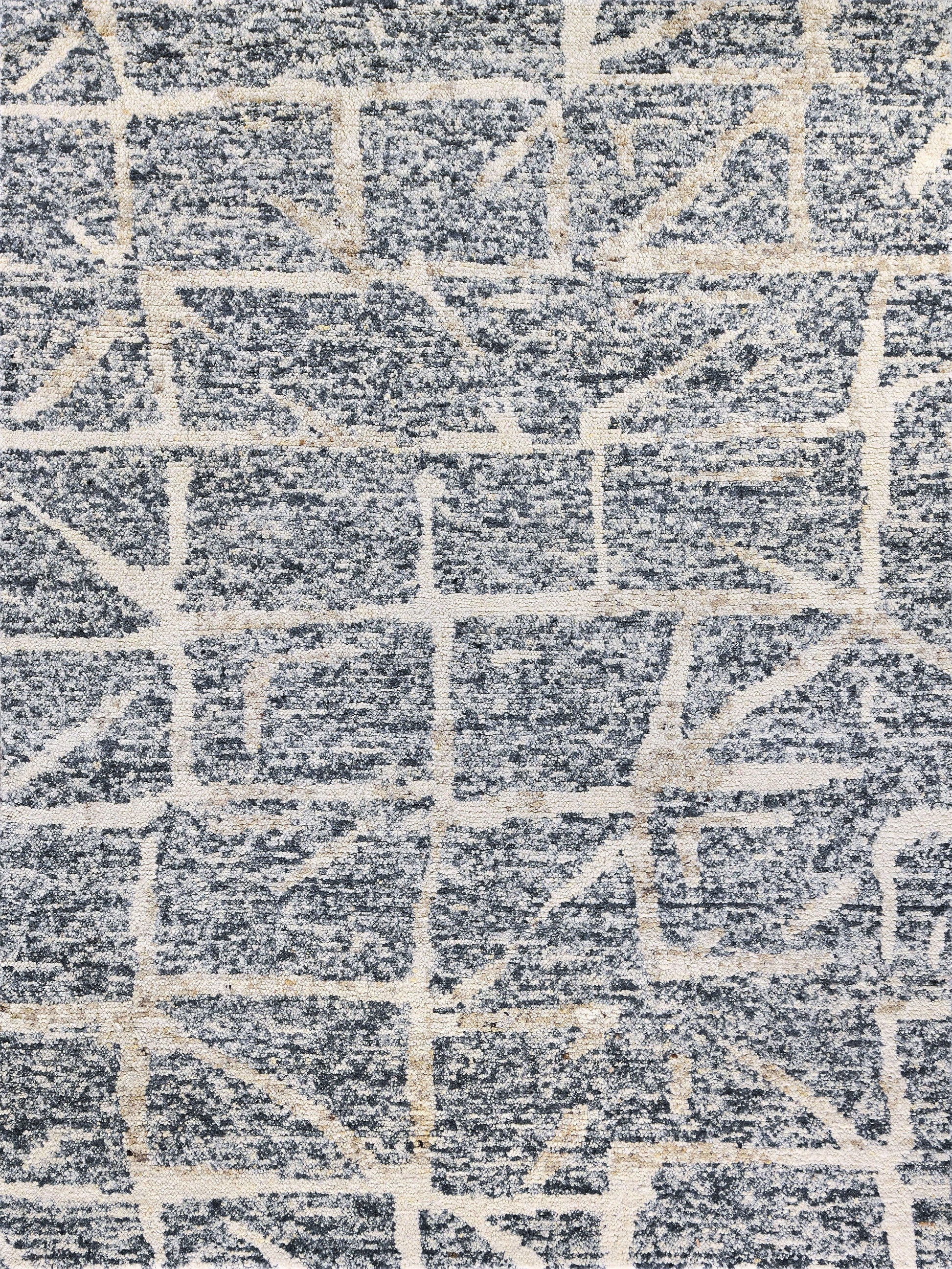 Rectangular blue-gray rug with cream geometric grid pattern and plush textured pile.