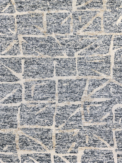 Rectangular blue-gray rug with cream geometric grid pattern and plush textured pile.