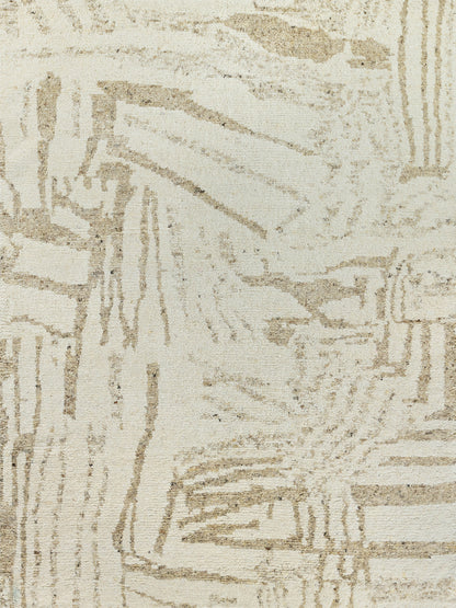 Beige and cream textured rug with abstract geometric pattern; woven neutral decor for living spaces.