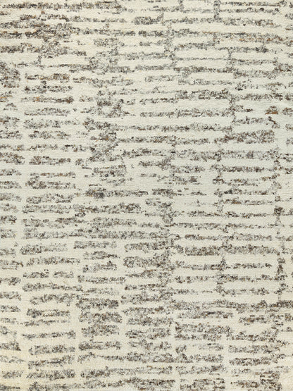 Beige area rug with cream base and brown brushed abstract pattern; soft textured floor covering.
