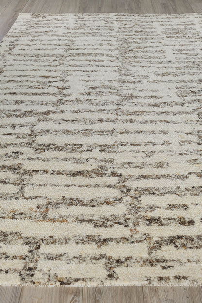 Beige cream area rug with abstract brown horizontal lines and a distressed pattern; modern living room decor.
