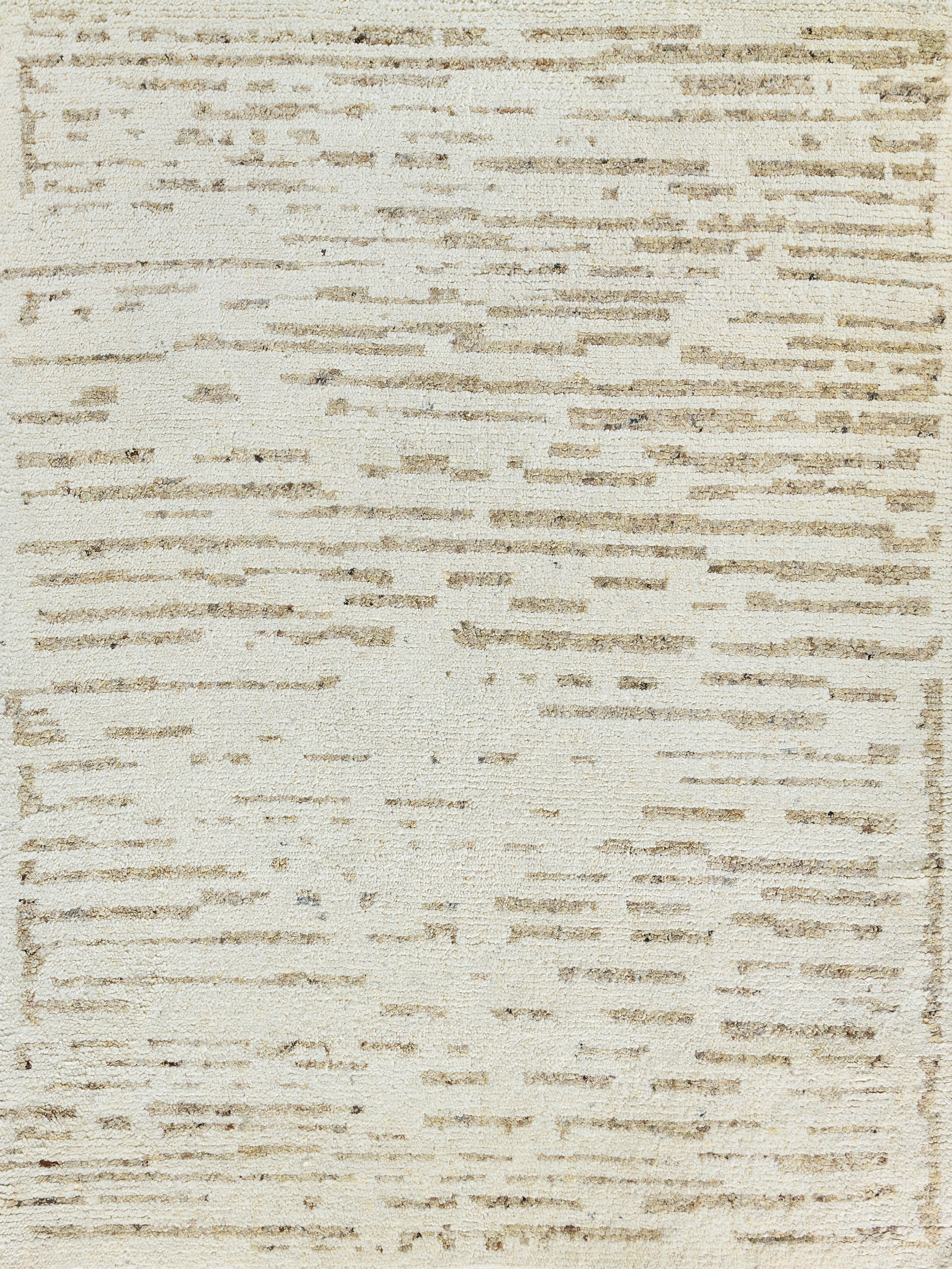 Beige woven rug with irregular tan stripes and a subtle border.