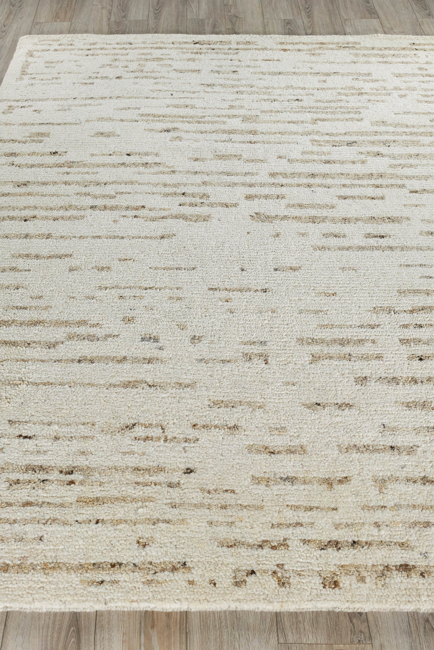 Cream rectangular area rug with light tan abstract dash pattern; soft plush texture, modern distressed style for living room.