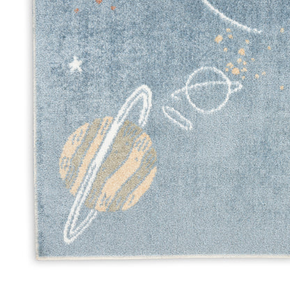 Blue denim rug featuring a beige ringed planet with white space orbits, stars and gold specks.