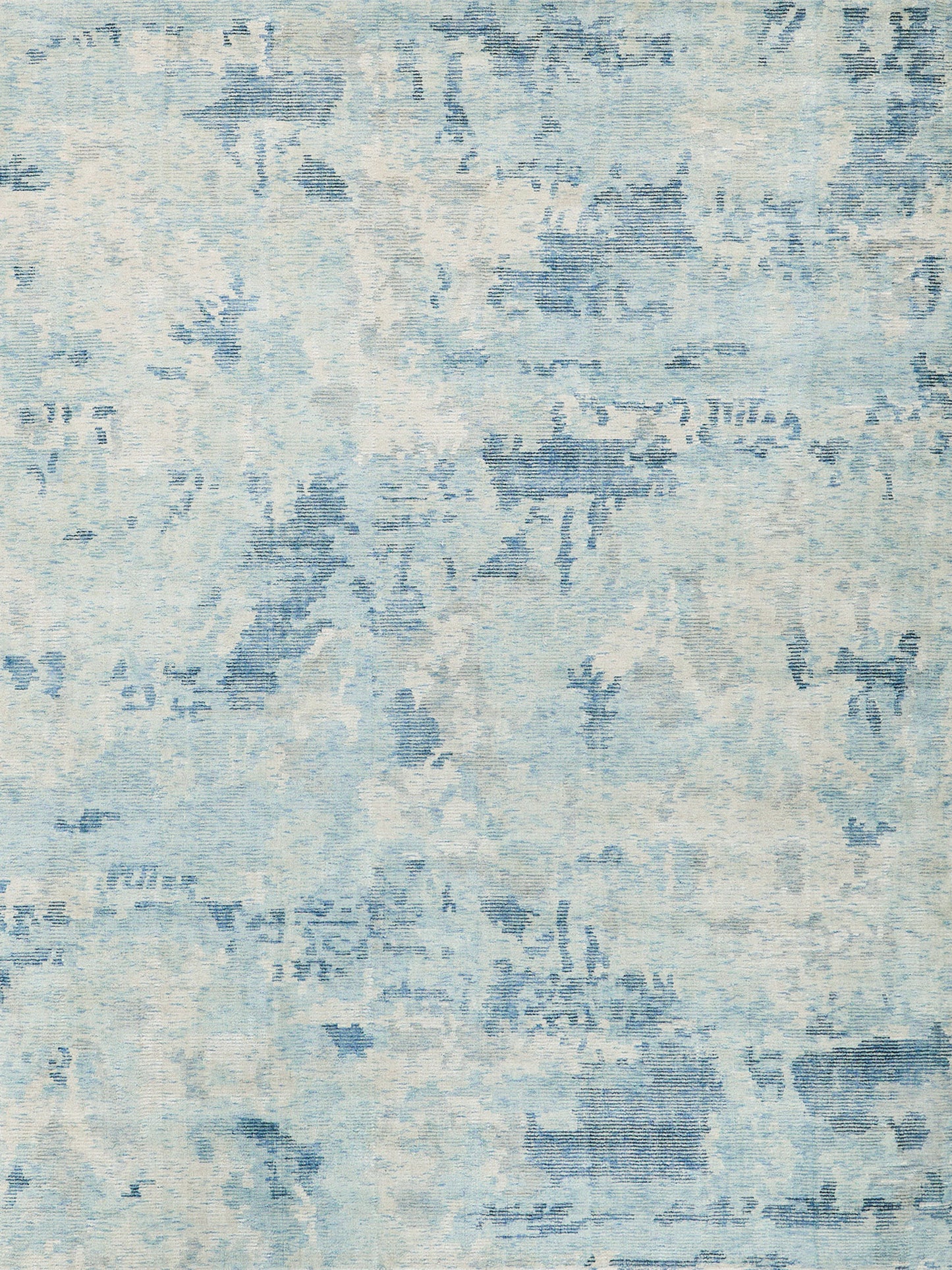 Blue and ivory abstract area rug with a washed, distressed pattern; hand loomed indoor rug, 6' x 9', suitable for living room or bedroom.