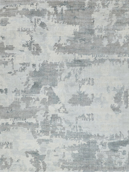 Blue-gray patterned area rug with a faded damask motif and woven texture for a modern vintage living room.