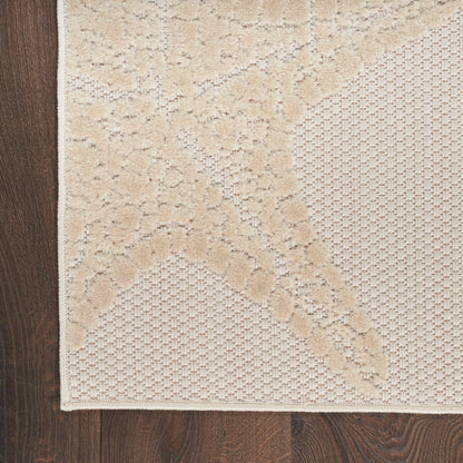 Beige rectangular outdoor rug with raised leafy damask pattern and textured lattice sections on floor.