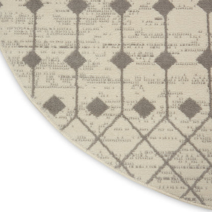 Beige round rug with taupe diamond lattice pattern in a woven textile.