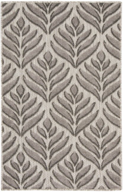 Taupe and beige woven rug with a repeating fern-like leaf pattern and textured surface.