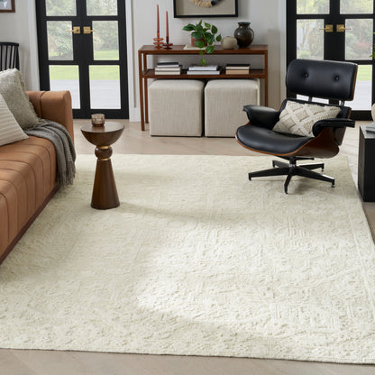 Mid-century living room: cream textured rug, black leather Eames-style lounge chair, brown sofa, wooden side table.