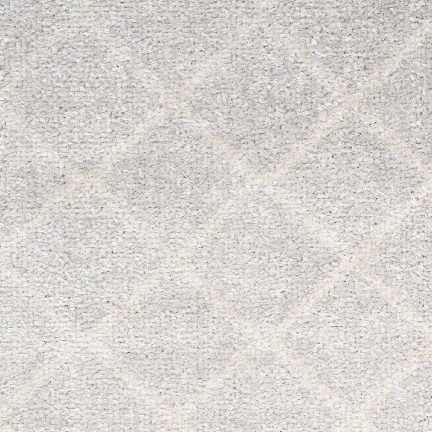 Light gray rug with a subtle diamond trellis pattern and soft plush texture.
