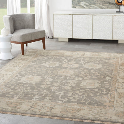 Beige-gray oriental area rug with a faded medallion pattern in a modern living room.