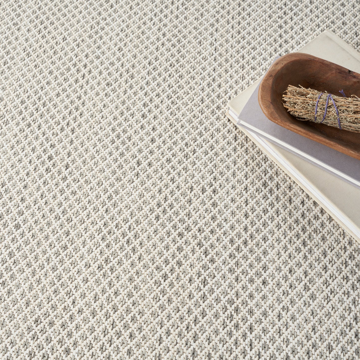 Beige rectangular swatch with smooth matte finish on textured gray fabric background.