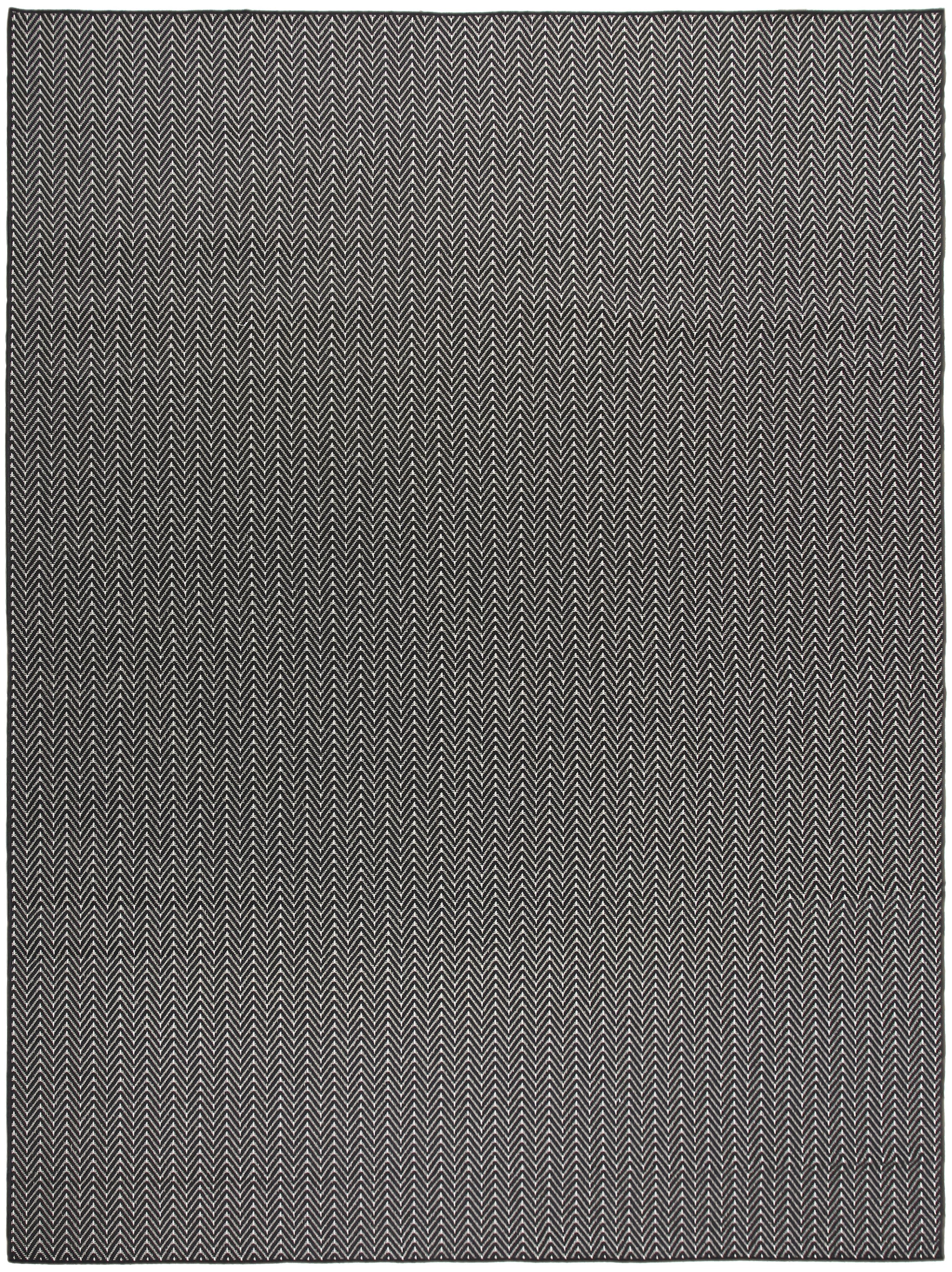 Rectangular woven rug with charcoal and cream herringbone pattern; modern, versatile living room decor.