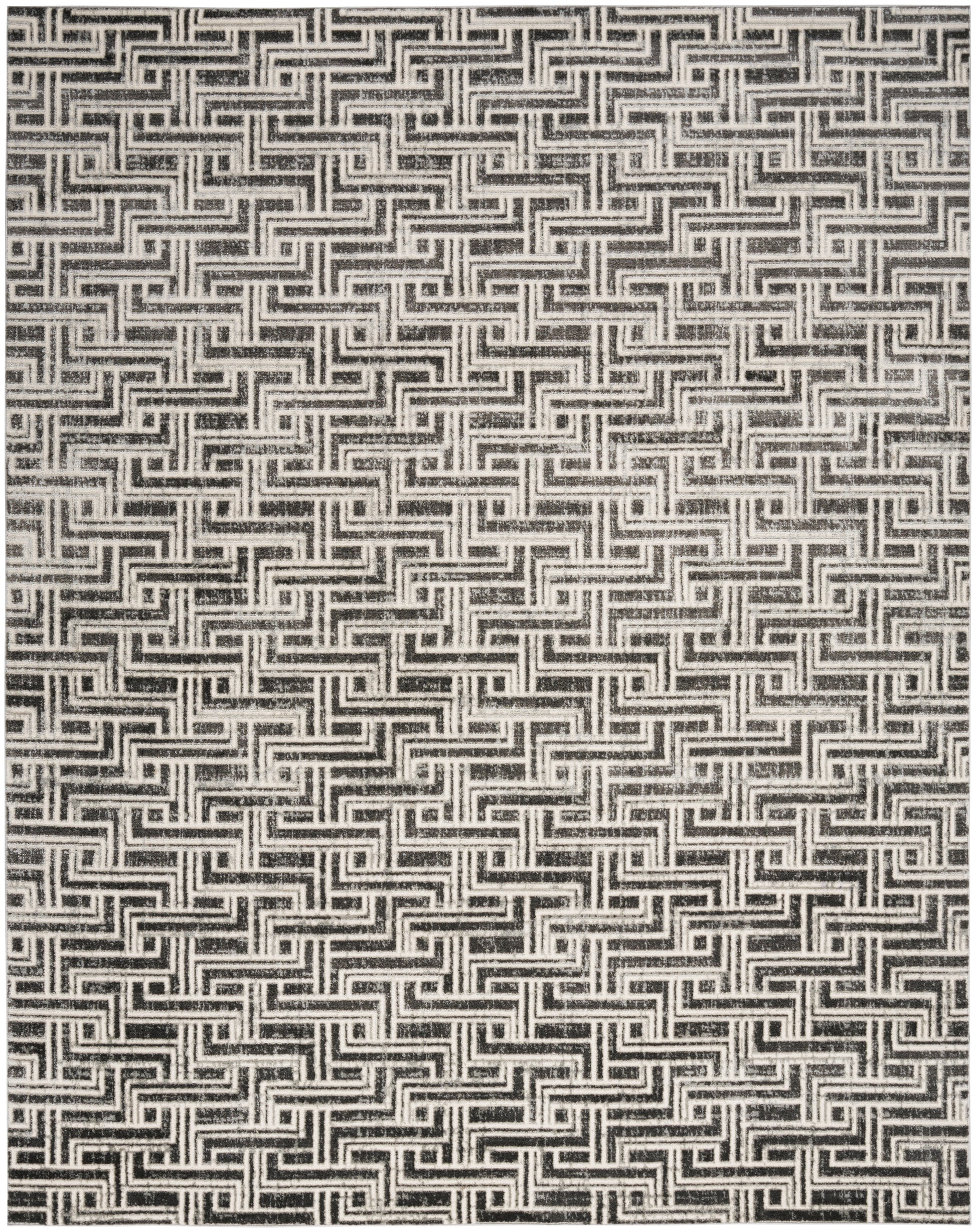 Black and white woven rug with a repeating Greek key maze pattern; bold geometric texture.