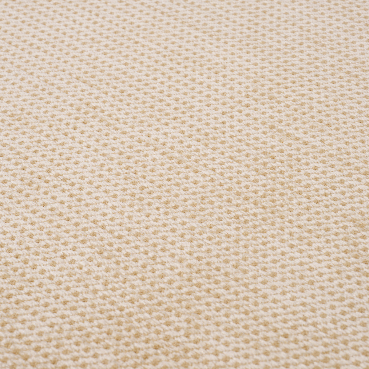 Beige textured waffle-knit fabric close-up with tiny honeycomb pattern; soft, breathable knit.