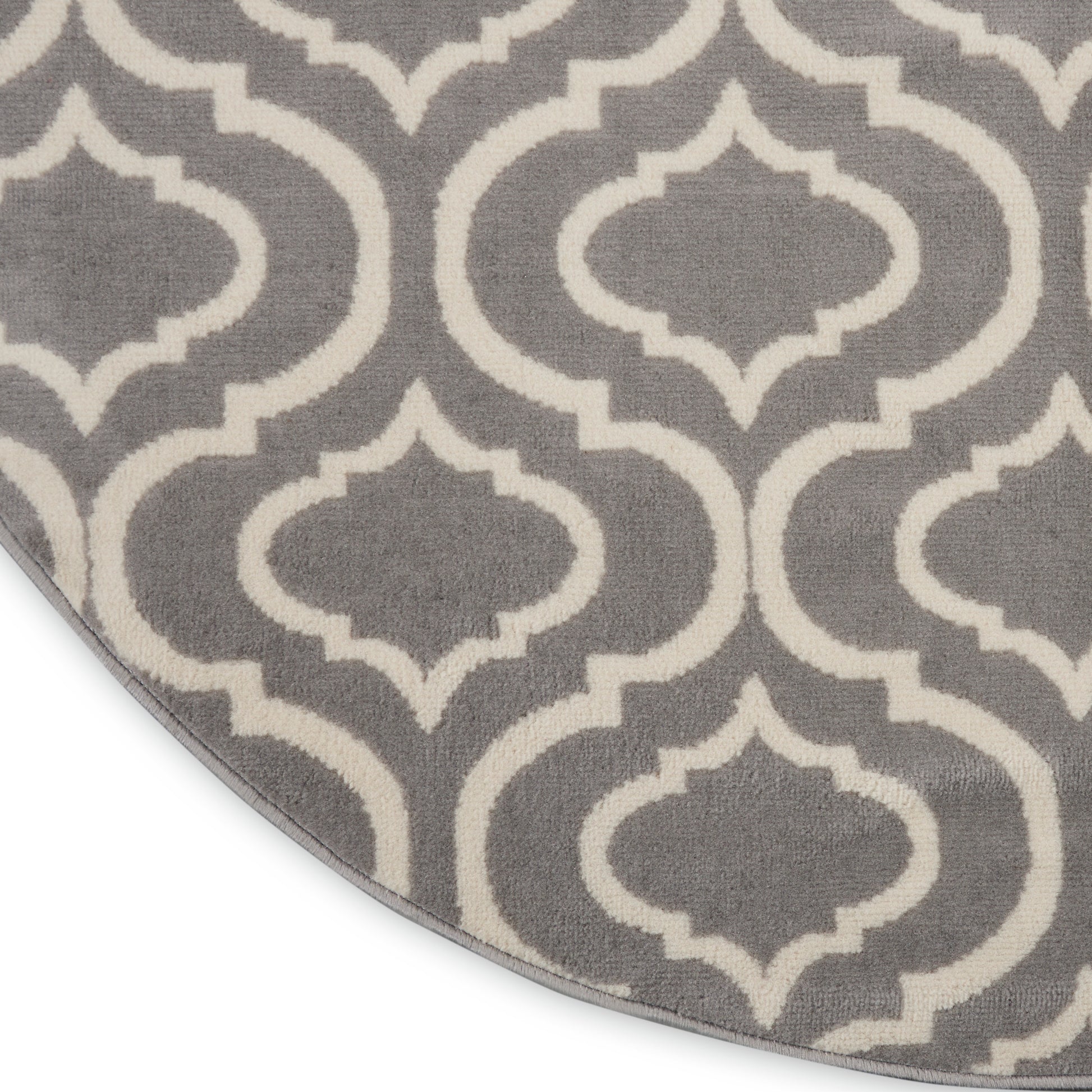 Gray round rug with white trellis pattern; soft woven texture for living room decor