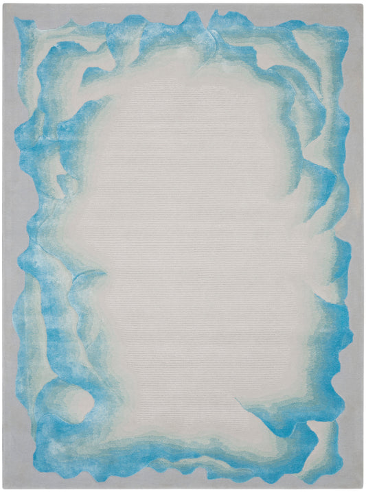 Rectangular flat-weave rug with pale beige inner field and irregular turquoise-blue border.