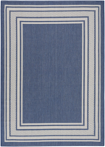 Rectangular navy blue rug with cream-white nested frame borders; woven texture, modern geometric floor decor.