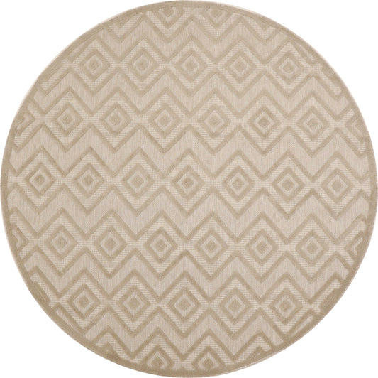 Round beige rug with a raised diamond chevron geometric pattern in cream tones.