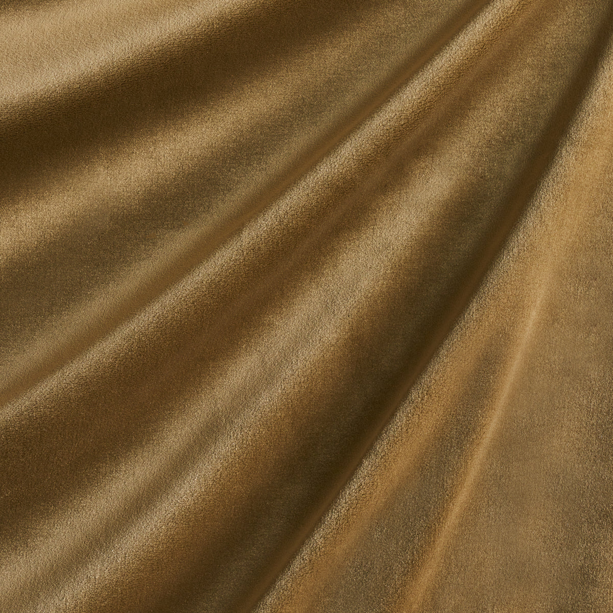 Golden velvet fabric with a soft nap and elegant draped folds.