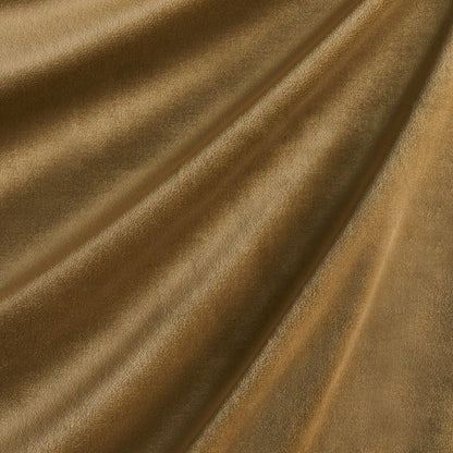Golden velvet fabric with a soft nap and elegant draped folds.