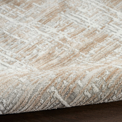 Beige and ivory patterned area rug with soft pile and subtle gray accents on dark wood floor.