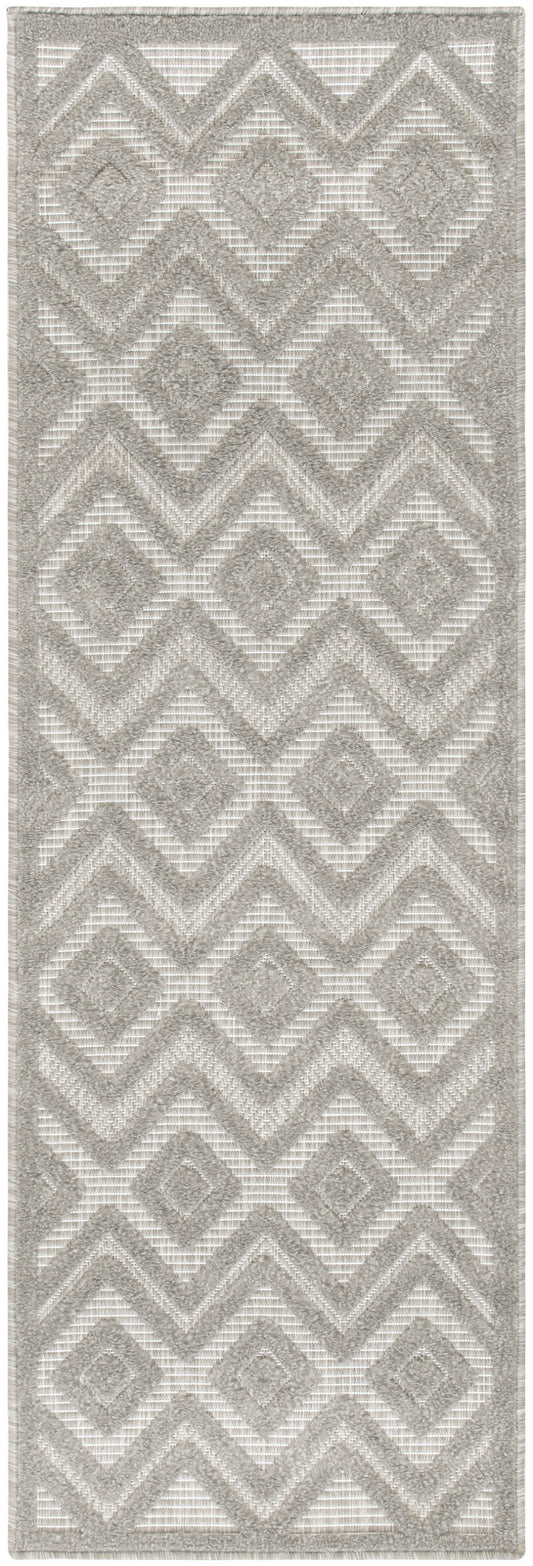 Light gray and ivory geometric runner with diamonds and chevrons, textured woven pile.