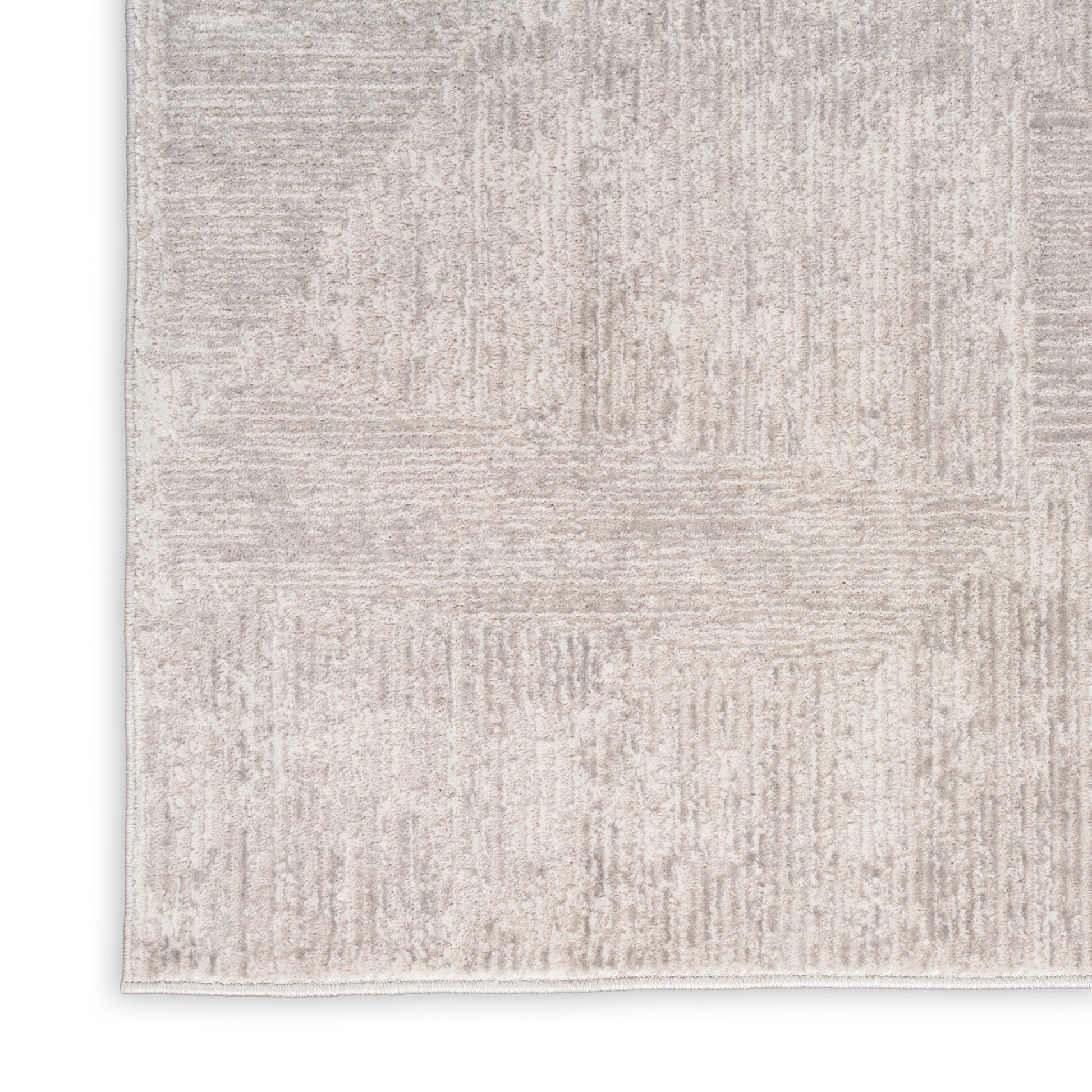 Beige-gray rectangular area rug with a subtle patchwork pattern and soft textured pile; ideal for modern neutral decor.