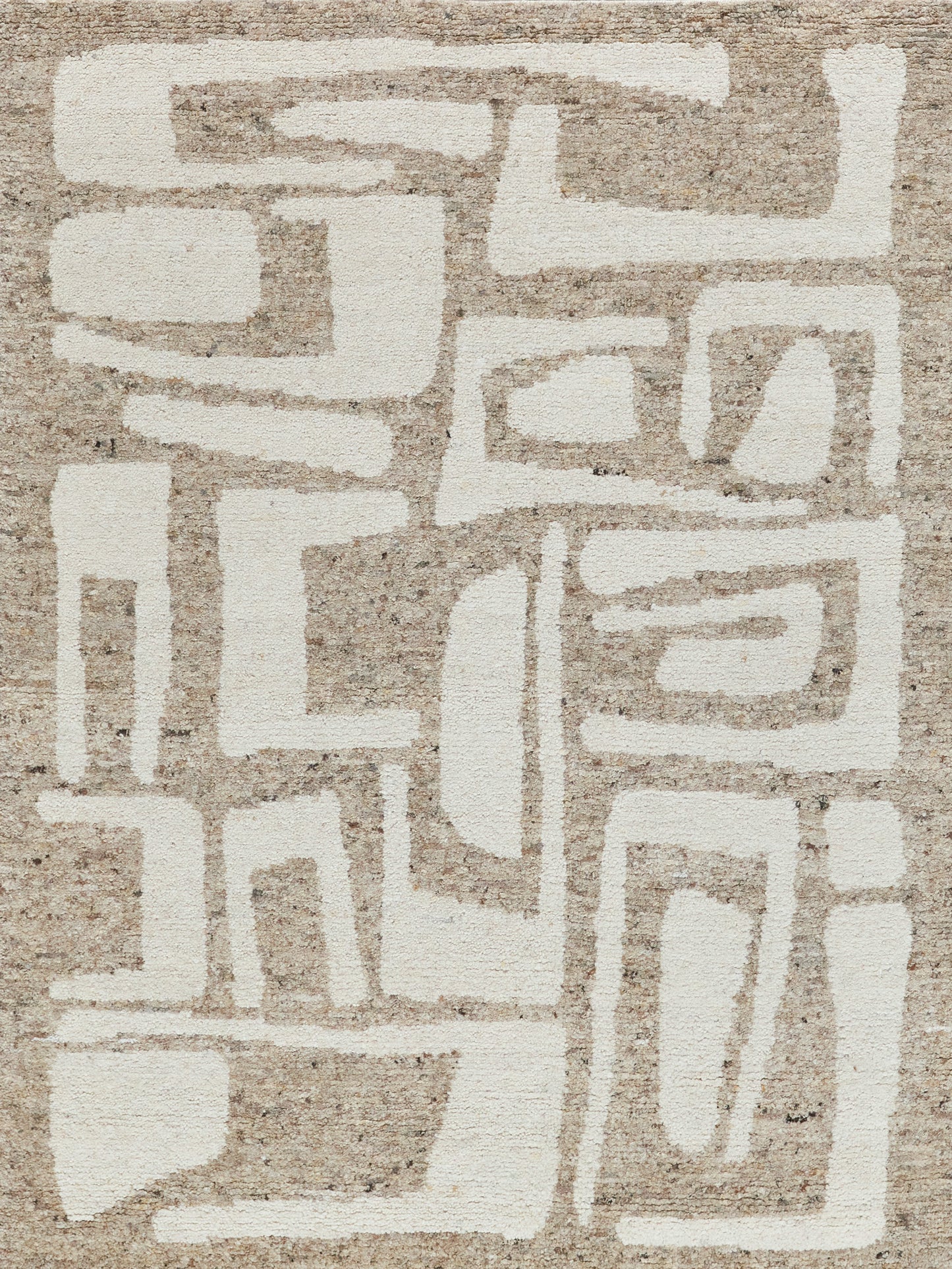 Beige woven rug with bold off-white geometric blocks forming an abstract maze-like pattern.