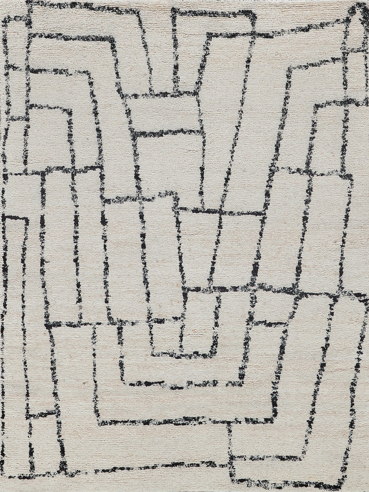 Beige rug with dark charcoal geometric maze pattern; loop-pile texture, modern contemporary style.