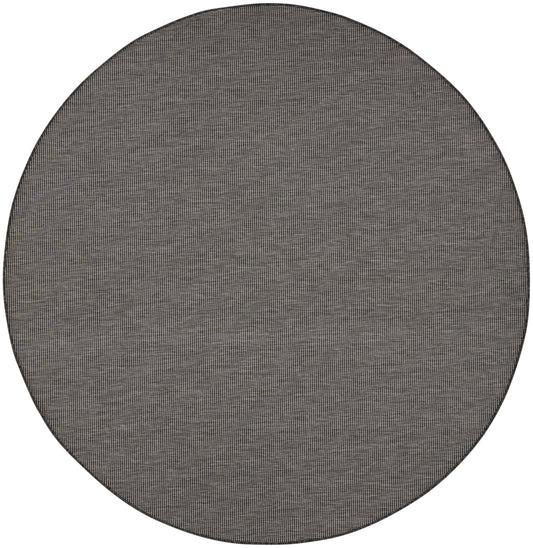 Round grey woven rug with subtle speckled texture, flat-weave style for modern living room decor.