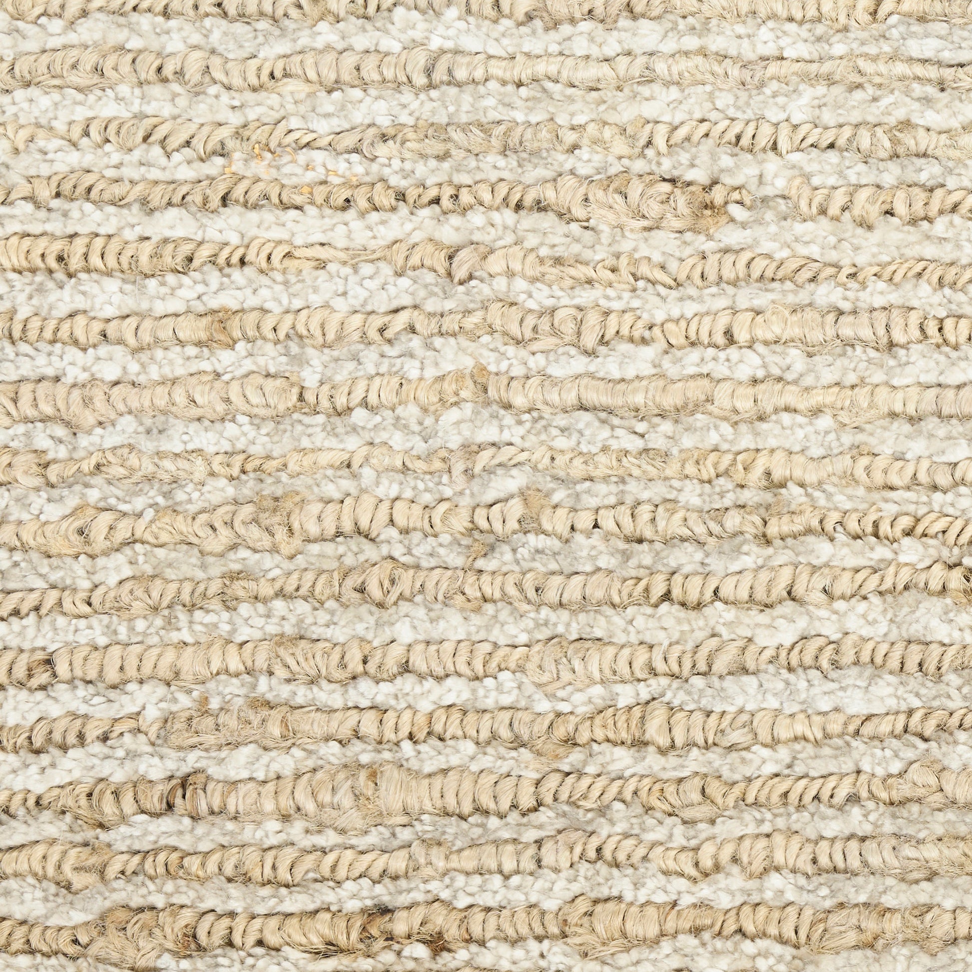 Natural beige looped jute rug close-up with chunky textured stripes; casual coastal style.