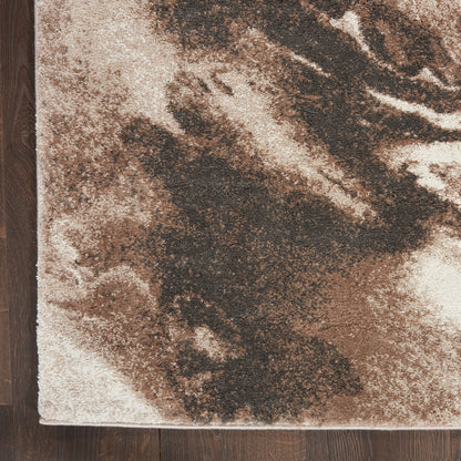 Brown & beige abstract marbled area rug on dark wood floor, edge visible.