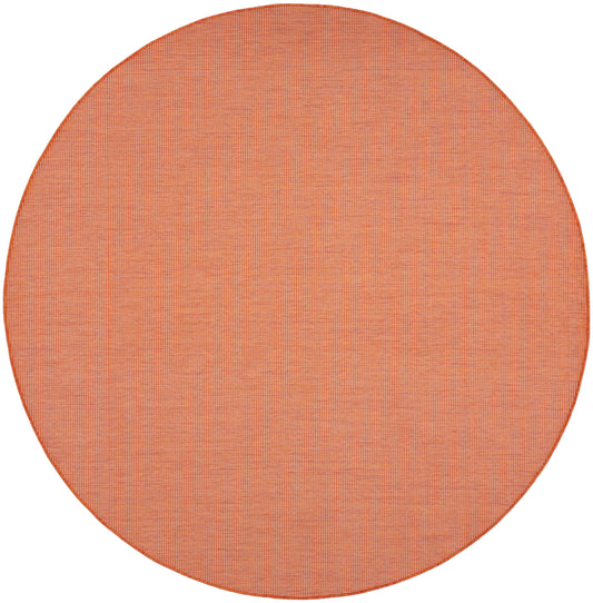 Round orange woven placemat with crosshatch texture, ideal for table setting.
