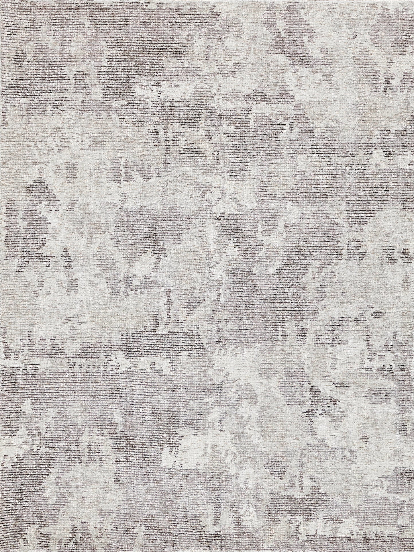 Soft neutral-toned distressed area rug with muted gray and cream abstract pattern.